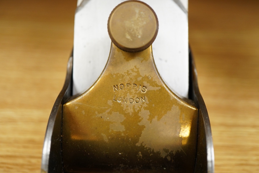 A Norris A1 adjustable steel 14 1/2” panel plane, stamped with Norris, London to both the brass lever cap and the iron, with rosewood infill